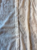White lace shirt with macramé hem
